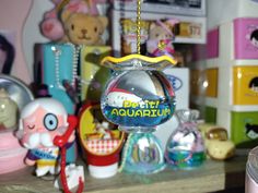 an ornament hanging from a chain on a table with other toys in the background