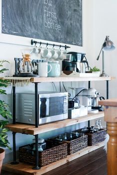 a coffee bar with lots of cups on it and a chalkboard above the counter