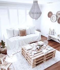 a living room filled with lots of white furniture