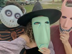 two people with masks on their faces and one is holding a mask in front of the other