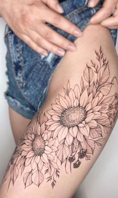 a woman's thigh with sunflowers on it