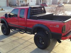 a red pick up truck parked in front of a house