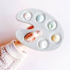 a person holding an egg tray with six eggs in it's palm and the top half of their hand