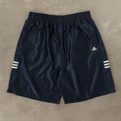 Men's Vintage Adidas Basketball Shorts  + Closure: Drawstring  + Colour: Navy Blue  + Size Label States: X-Large  + Actual measurements (inches): X-Large  + Measurements (Inches): Hem = 14, Rise = 16  Please note that all vintage items have been previously worn, and may show some signs of previous wear. However, any significant damage will be photographed and/or stated in the items listing. Please note that damage to the inside may not always be photographed or listed. Blue Athletic Shorts With Drawstring, Vintage Basketball, Sporty Shorts, Basketball Clothes, Adidas Vintage, Adidas Shorts, Size Label, Basketball Shorts, Vintage Adidas