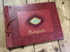 a red book sitting on top of a wooden floor