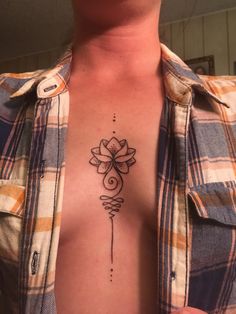 a man's chest with a tattoo on it and a flower in the middle