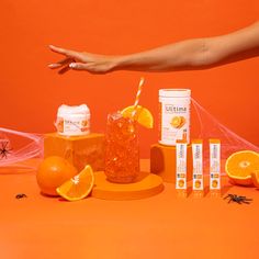 an orange table topped with lots of different types of juices and condiments