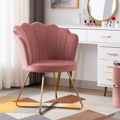 a blue chair sitting in front of a mirror on top of a desk next to a dresser