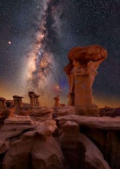 the milky is shining brightly in the sky above some rocks