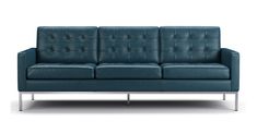 a blue leather couch sitting on top of a metal frame