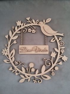 a wooden sign that says ben vanda hanging from a chain with flowers and birds on it