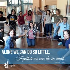 a group of people standing on top of a hard wood floor next to each other