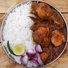 a plate with rice, meat and vegetables on it