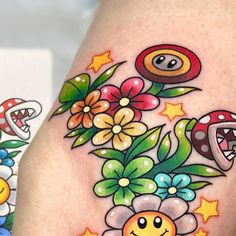 a close up of a person's leg with tattoos on it and flowers in the background