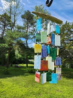 a wind chime made out of stained glass blocks and a skateboard hanging from it