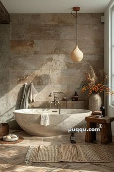 a bath tub sitting next to a window in a bathroom with stone walls and flooring