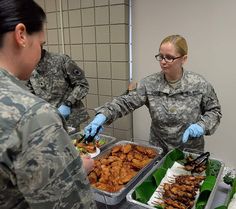 two women in uniform serving food to each other