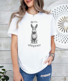 This cute and whimsical "Bunny Whisperer" T-shirt will become a new favorite in your wardrobe! This minimalist but tasteful design will also make a meaningful gift for any bunny lover! The classic unisex jersey short sleeve tee fits like a well-loved favorite. Soft cotton and quality print make users fall in love with it over and over again. These t-shirts have-ribbed knit collars to bolster shaping. The shoulders are tapered for a better fit over time. Dual side seams hold the garment's shape f Whimsical Bunny, Bunny Lovers, Cute Rabbit, Print Tee, Leisure Wear, Jersey Shorts, Tee Shirt, Short Sleeve Tee, Ribbed Knit