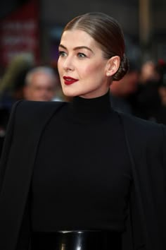 a woman in black dress and red lipstick