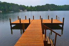 a wooden dock sitting in the middle of a lake