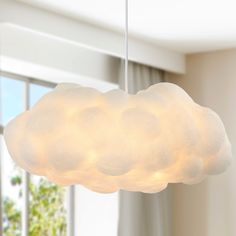 a white cloud shaped light hanging from a ceiling