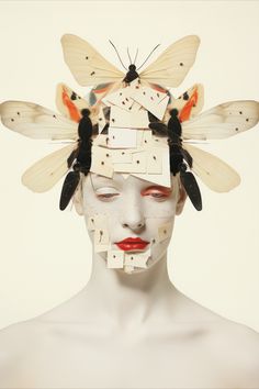 a woman's head with moths on it and the image is made up of multiple pieces