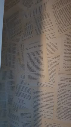 the wall is covered with many different types of paper