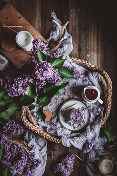 purple flowers and tea on a wooden table