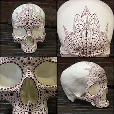 four different views of a white skull with intricate designs