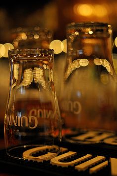 two glass carafes sitting on top of a table