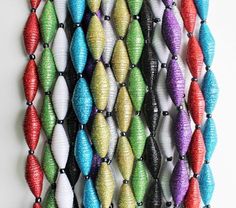 multicolored beaded necklaces hanging on a wall