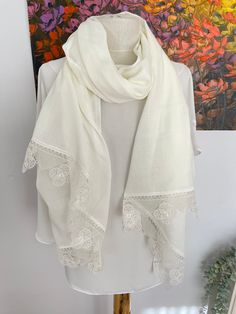 Off white Pashmina Shawl with beautiful lace.  These unique pashmina shawls make the perfect gift and wedding favor for all your lady guests. Also great for bridal Showers, Birthdays and special occasions. Produced in pet and smoke free environment.  Please wash by hand with warm water and soap. No machine dry. Fabric length (except lace) : 70'' x 25'' (1,80m x 65 cm) Material: Polyester , Very Soft and Lightweight. Suitable for all seasons.  EXPRESS Shipping Upgrade for 4+ pieces   Buy at least Elegant Shawl Scarf With Lace Trim, Elegant Lace Trim Shawl Scarf, Elegant Lace Shawl Scarves, Lace Dupatta With Lace Trim, Elegant Lace Dupatta, Lace Work Dupatta For Wedding, Cream Bohemian Pashmina Shawl For Wedding, Elegant White Dupatta, Elegant Wedding Dupatta With Lace Trim