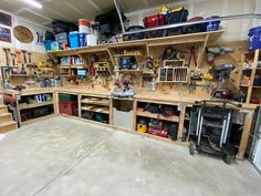 a garage filled with lots of work tools and storage shelves on the wall next to each other