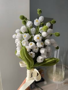 a bouquet of white flowers with green stems