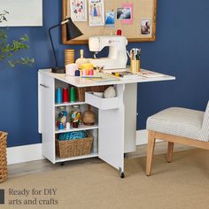 a sewing machine sitting on top of a white table next to a chair and wall