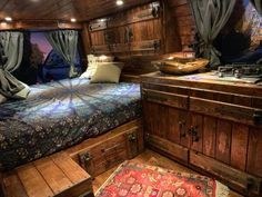 a bed sitting inside of a bedroom on top of a wooden floor next to a dresser