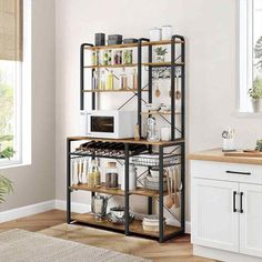 a kitchen with white walls and wooden floors