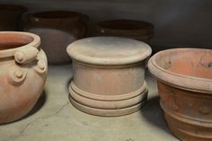 several clay pots are lined up on the floor