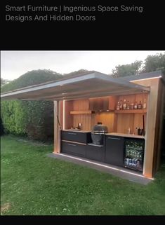 an outdoor bar in the middle of a yard with green grass and trees behind it