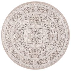 a round rug with an intricate design on the center and sides, in beige tones