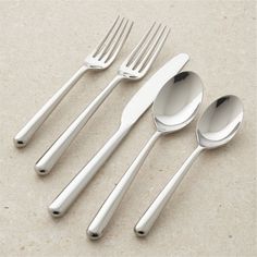 four forks, two spoons and one knife on a table