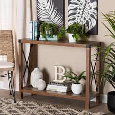 a wooden table topped with plants and books