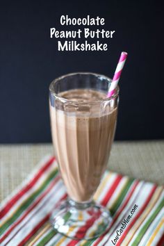 chocolate peanut butter milkshake in a glass with a pink and white striped straw