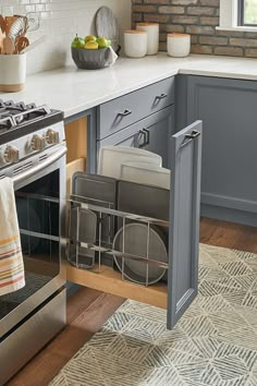 a kitchen with an oven, dish rack and other items on the counter top in front of it