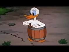 donald duck is sitting on top of a barrel