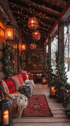 a porch covered in christmas lights and decorated with garlands, lanterns, and ornaments