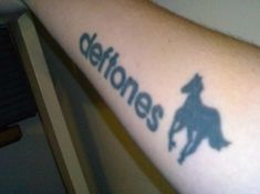 a person with a tattoo on their arm that says detoness and a horse