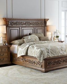 a large bed sitting in a bedroom next to two nightstands