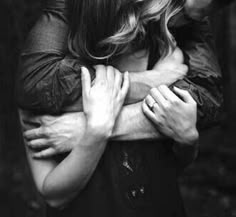 black and white photograph of two people hugging each other