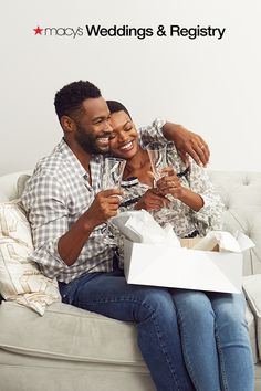 a man and woman are sitting on a couch